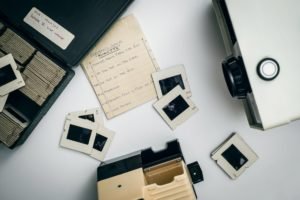 white and black projector on white surface beside case